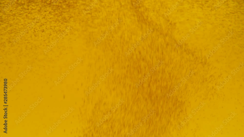 beer with bubbles in glass. Fine bubbles rising in glass with range liquid. beer with bubbles in glass. Fine bubbles rising in glass with range liquid.