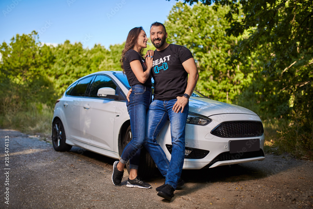 Happy couple with their new modern car Happy couple with their new modern car