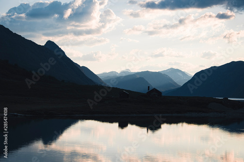 Silhouttes of House and Mountains at Gjende Fjord, Jotunheimen National Park