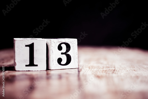 Number 13 isolated on dark background- 3D number thirteen isolated on vintage wooden table