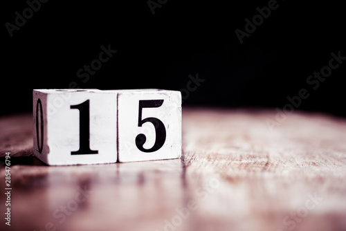 Number 15 isolated on dark background- 3D number fifteen isolated on vintage wooden table