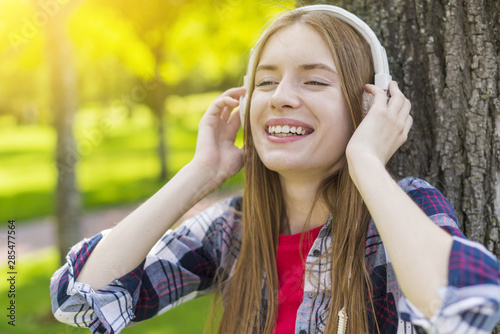 Blonde girl listening to music on headphones