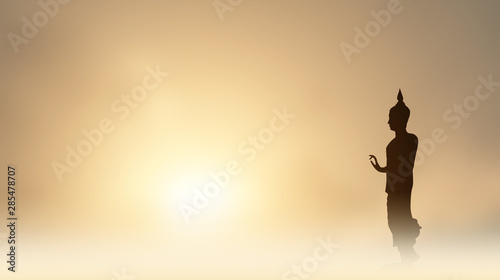 Buddha statue,  Silhouette Buddha on golden sunset background, Concept of important days in Buddhism, Visakha Puja Day