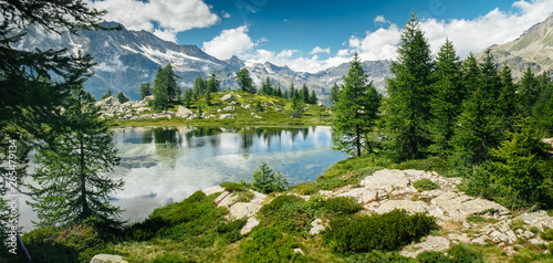 Mountain landscape with a lake and green trees around. Sense of freedom. Gran Paradiso National Park, Bellagarda lake, Ceresole Reale, Piedmont, Italy © Codegoni Daniele