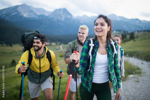 Group of hikers walking on a mountain and smiling