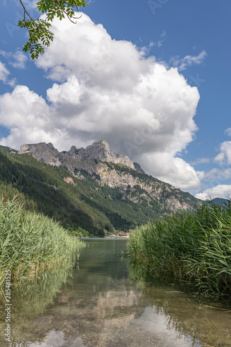 idyllic view over the Haldensee in the Tannheim valley, Tirol, Austria, with the summits of Rote Flue and Gimpel in the background