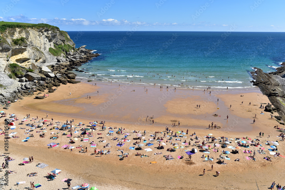 People on the Playa de Los Molinucos Beach in Santander, Cantabria, North Spain