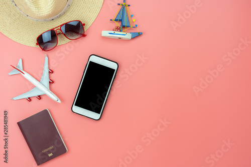 Flat lay image of accessory clothing man or women to plan travel in holiday background concept.Mobile phone & passport with many item in vacation season.Table top view several object on pink paper.
