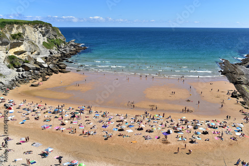 People on the Playa de Los Molinucos Beach in Santander, Cantabria, North Spain © akturer