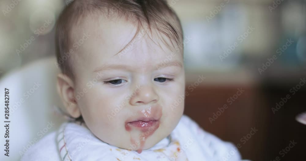 Baby boy eating currant puree Baby boy eating currant puree