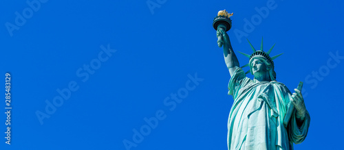 Panoramic of The Statue of Liberty in New York City. Statue of Liberty with blue sky over hudson river on island. Landmarks of lower manhattan New York city.