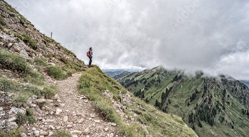 senior woman hiking in autumnal atmosphere on the ridge of the Nagelfluh chain near Oberstaufen, Allgaeu area, Bavaria, Germany