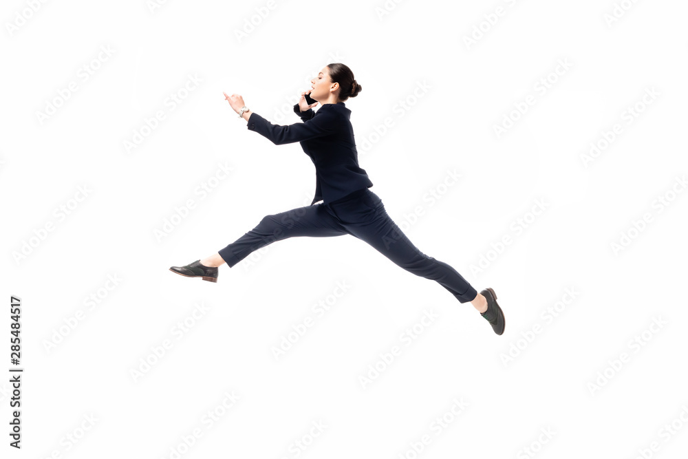 beautiful businesswoman levitating while talking on smartphone isolated on white