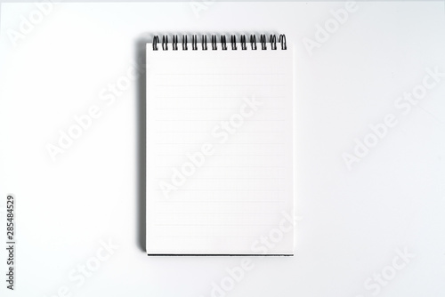 Notebook mock up with clean black blank for design and advertising. Notepad with chromed spring and free copy space template. On the gray background.