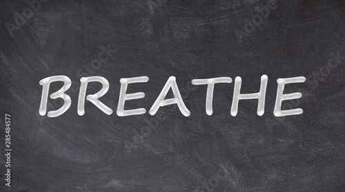 Breathe text written on blackboard