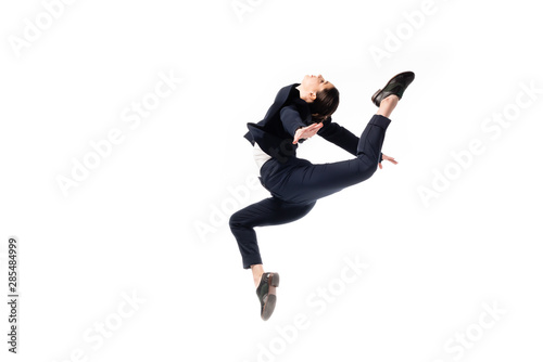 graceful businesswoman in formal wear jumping in dance isolated on white photo