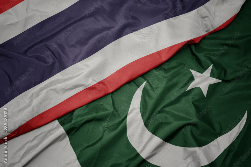 waving colorful flag of pakistan and national flag of thailand.