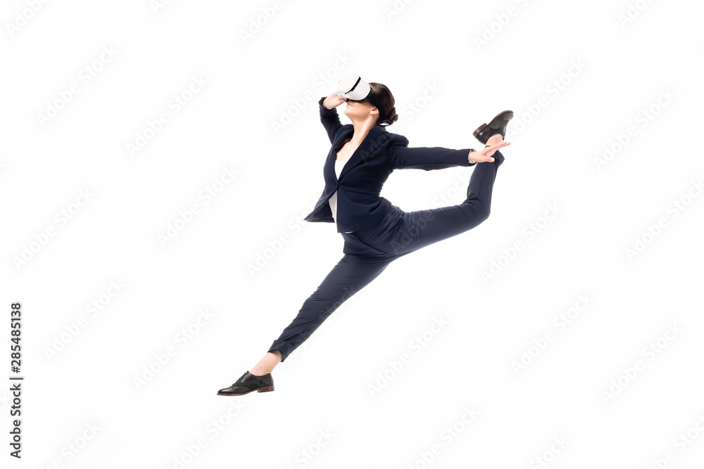 young businesswoman dancing while using virtual reality headset isolated on white