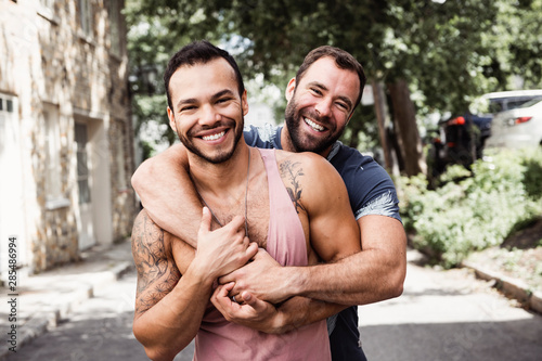 A Portrait of a happy gay couple outdoors in urban background
