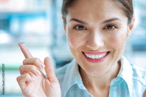 Wallpaper Mural Joyful happy woman holding the eye lens Torontodigital.ca