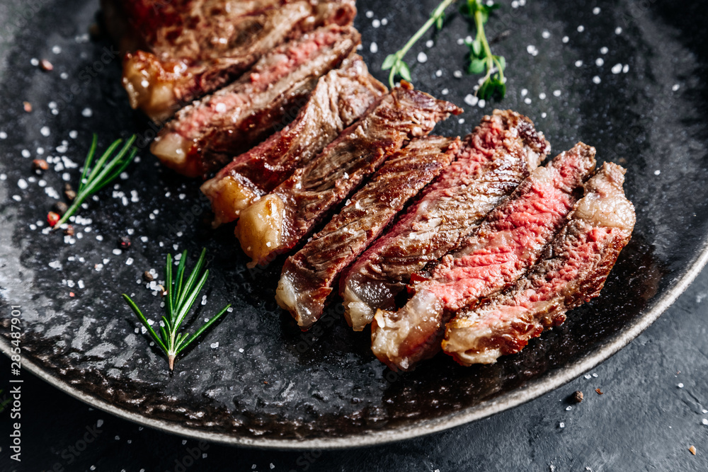 New York Strip steak medium rare with rosemary top view 