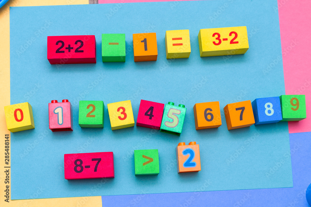 child kid colorful education toys cubes with numbers math pattern background on the bright background. Flat lay. Childhood infancy children babies concept. child kid colorful education toys cubes with numbers math pattern background on the bright background. Flat lay. Childhood infancy children babies concept.