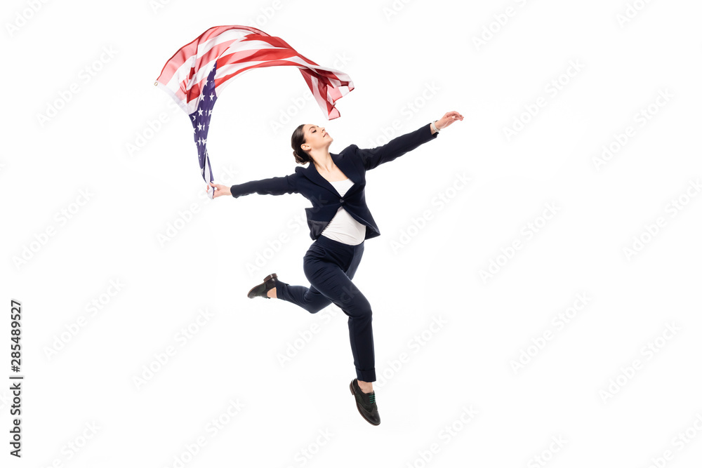 graceful businesswoman in formal wear dancing with united states of america national flag isolated on white