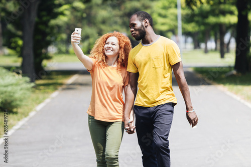 Couple holding hands while taking a selfie