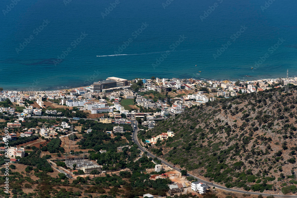 Crete, Greece. June 2019. An overview of Malia a popular seaside resort in central Crete seen from the Lasithi Mountains area.