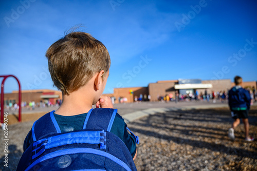 Caucasian boy with back pack on first day of school  photo