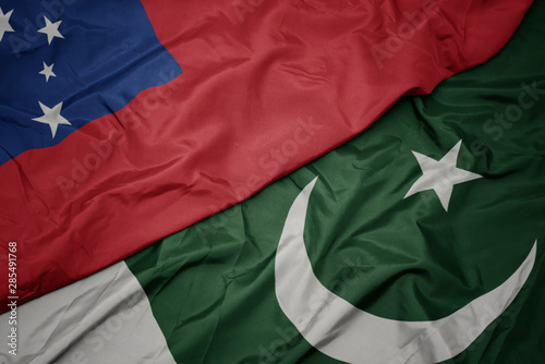 waving colorful flag of pakistan and national flag of Samoa.