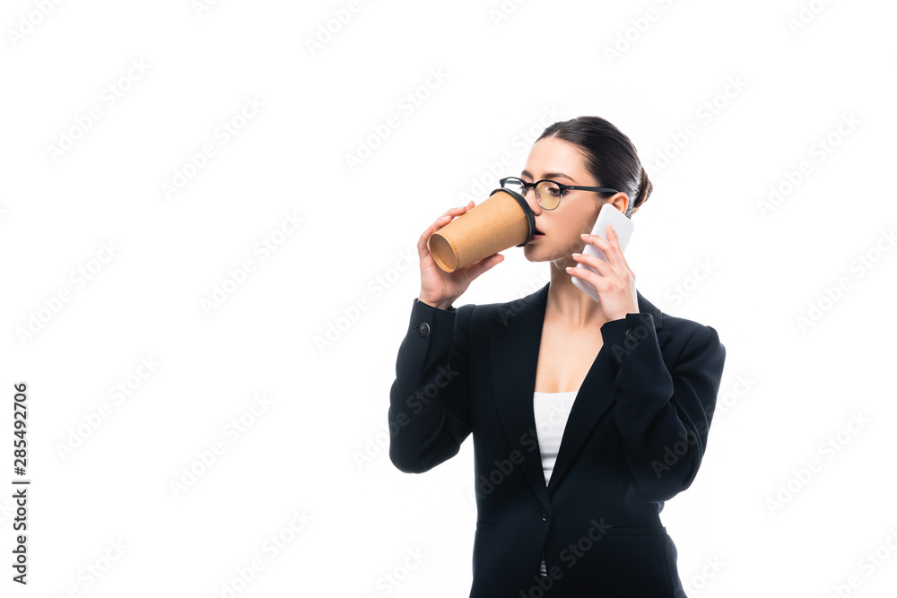 young businesswoman drinking coffee to go while talking on smartphone isolated on white young businesswoman drinking coffee to go while talking on smartphone isolated on white