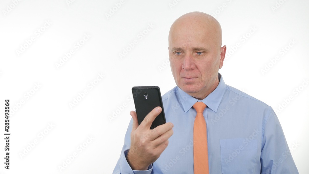 Confident Businessman Image Reading Message Using a Cellphone Confident Businessman Image Reading Message Using a Cellphone