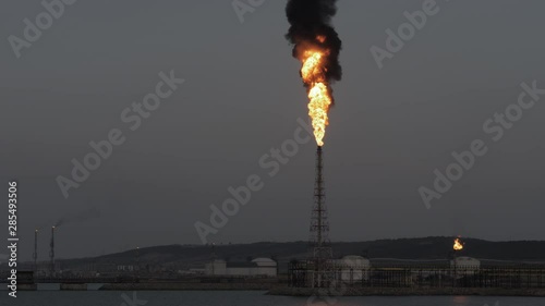 Gas flare and smoke of petrochemical refinery in twilight