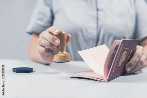 Immigration and passport control at the airport. woman border control officer puts a stamp in the passport. Concept