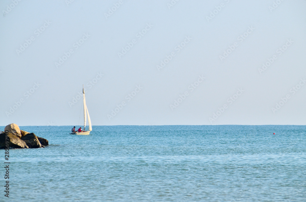Sailboat sails gently on the sea