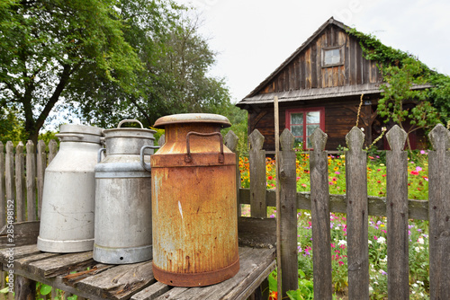 Old milk cans in The Folk Culture Museum in Osiek by the river Notec, the open-air museum presents polish folk culture. Poland, Europe