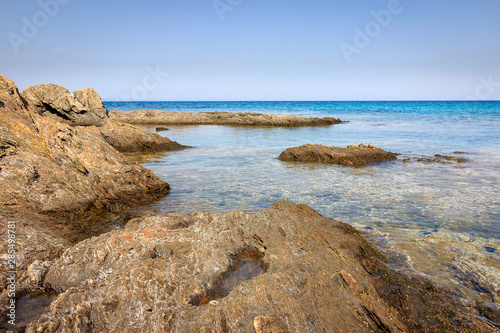 Calm translucent turquoise sea, beautiful rocky reef and underwater sea creatures photo