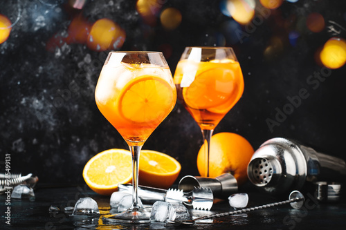 Fotografie Aperol spritz cocktail in big wine glass with orange and ice, summer alcoholic c