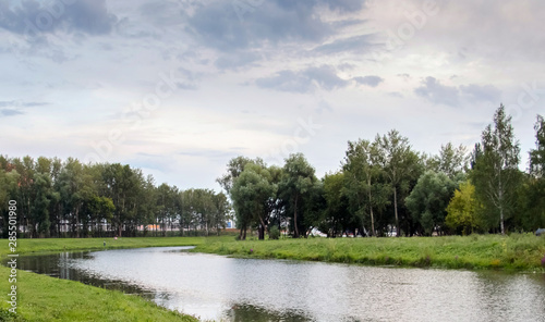 Beautiful sky on the Insar. Forest river landscape. River forest view. Forest river summer scene. Forest river water