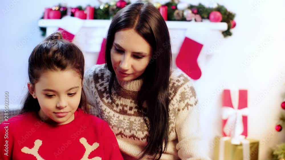 mother and daughter reading book on christmas mother and daughter reading book on christmas