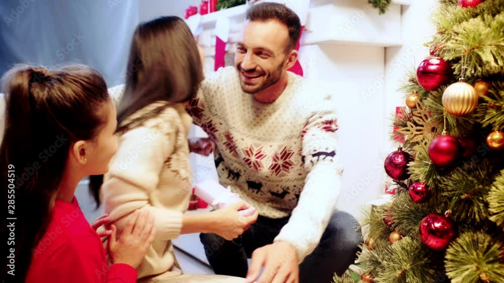 cheerful father giving presents to family cheerful father giving presents to family