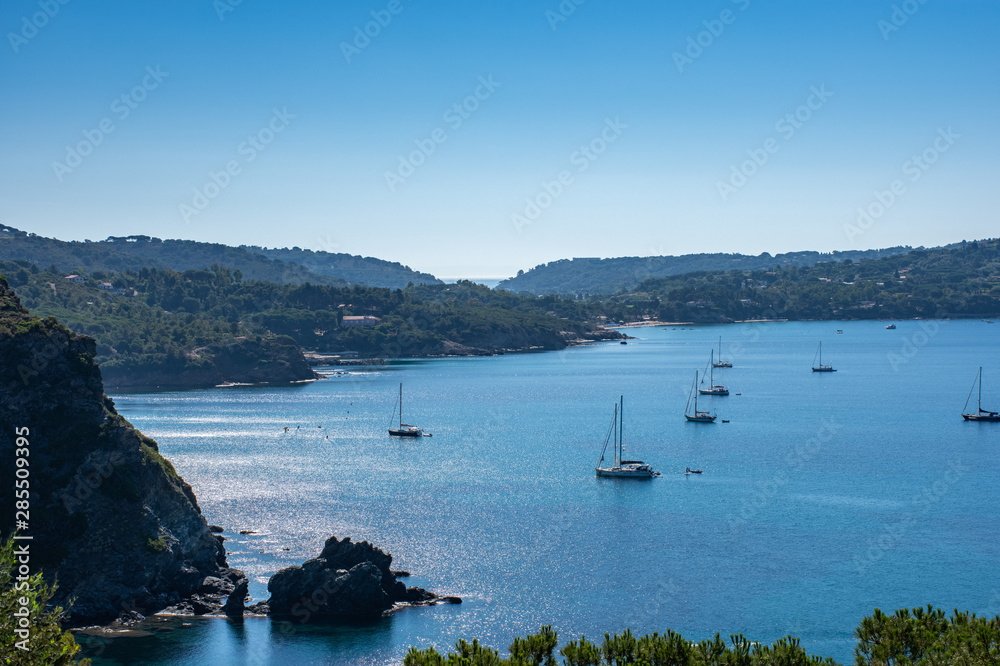 Splendid panoramic view of the crystal blue sea of the island of Elba in Italy with boats on the horizon