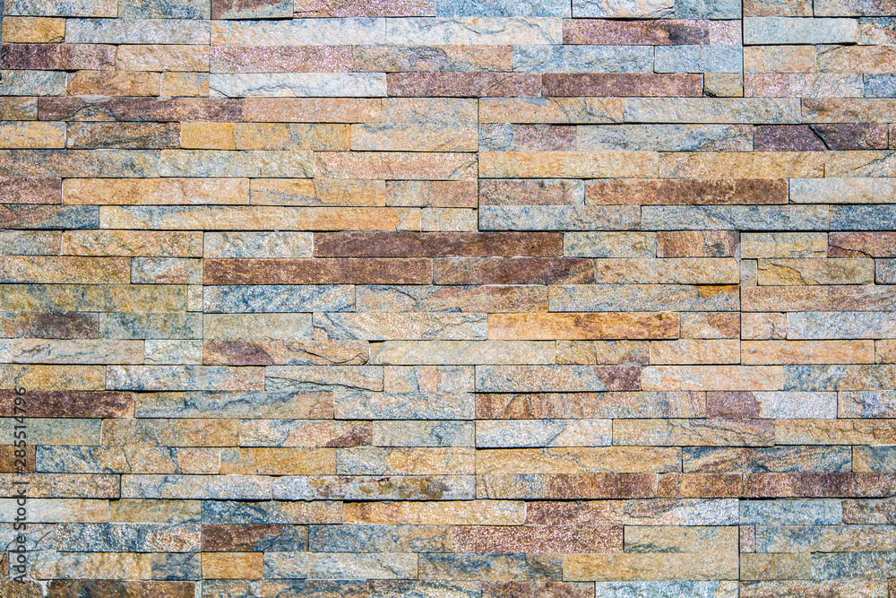 Naklejka premium Decorative texture of a beautiful wall with rectangular parts of multi-colored artificial stone...