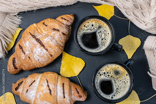 Tasty autumn breakfast with fresh croissants and two cups of aromatic coffee. Hygge style composition. photo