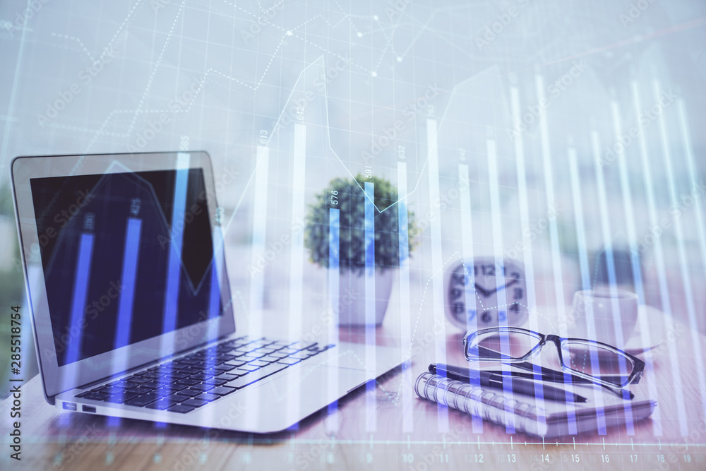 Forex graph hologram on table with computer background. Multi exposure. Concept of financial markets. Forex graph hologram on table with computer background. Multi exposure. Concept of financial markets.