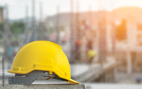 yellow hard safety wear helmet hat in the project at construction site