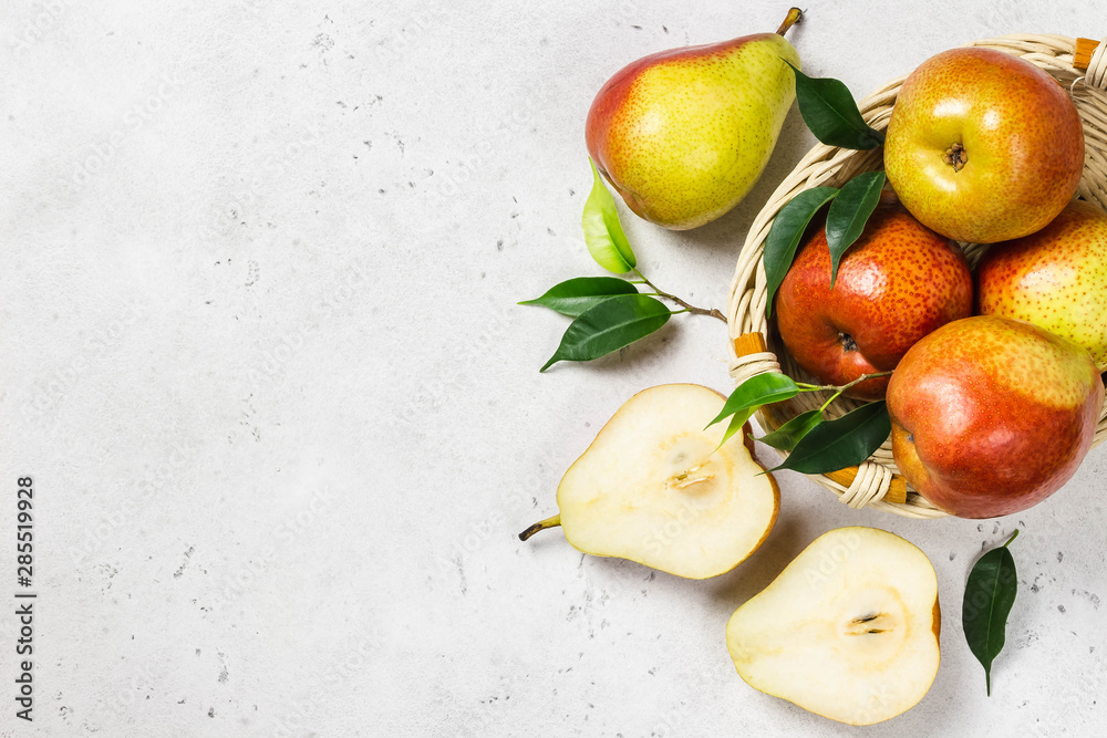 Ripe colourful pears sliced on cutting board. Top view, space for text. Ripe colourful pears sliced on cutting board. Top view, space for text.