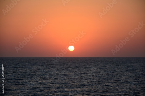 Sunset at sea in tropical terrain