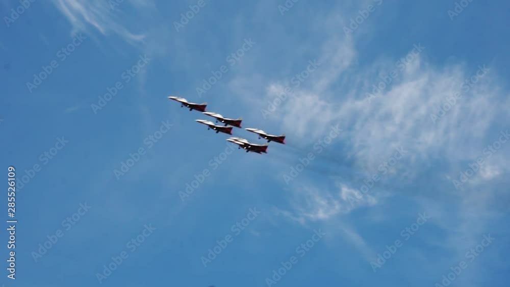 Military plane team modern fighters in flight in the sky right in left, slow motion Full HD Video